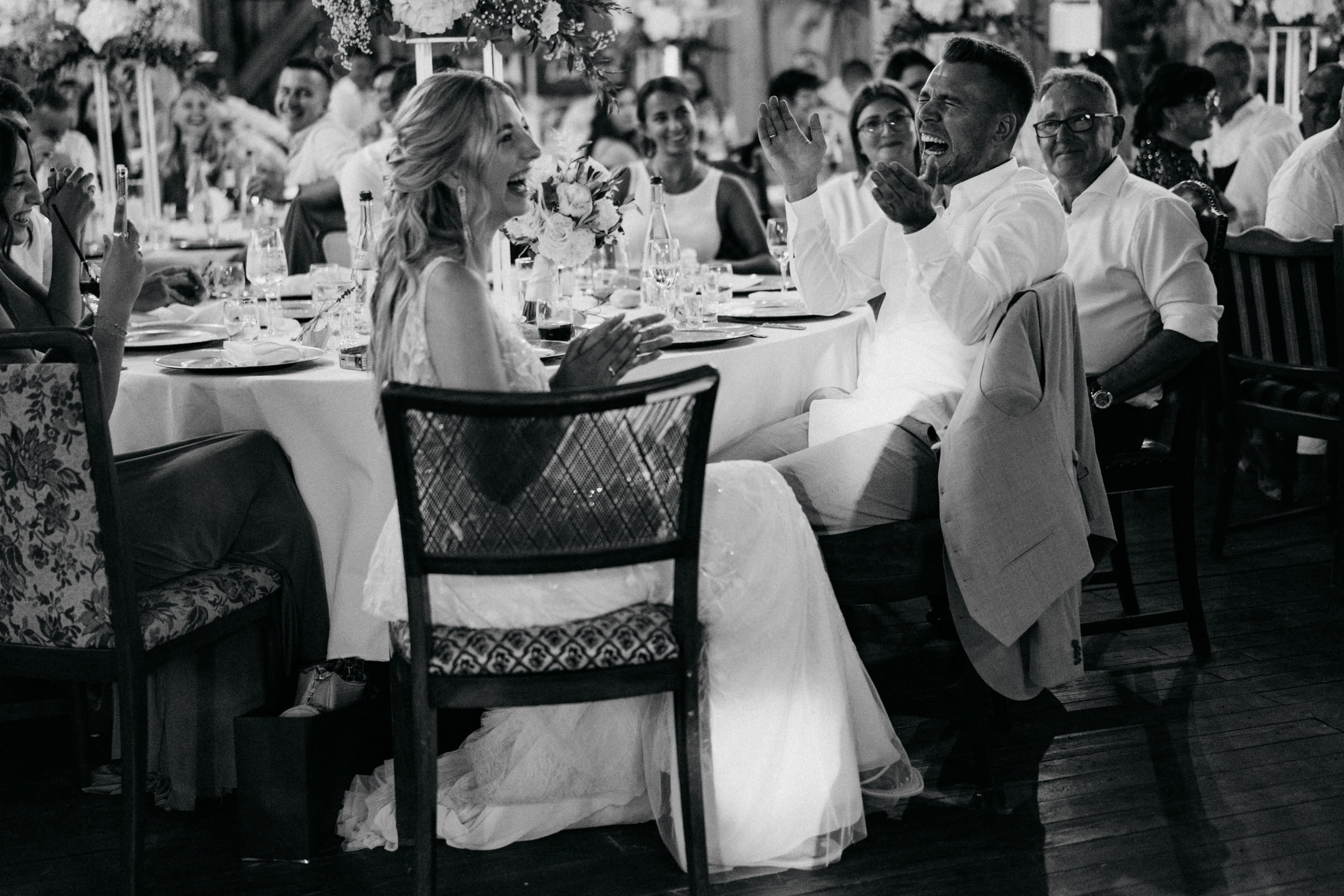 Joyful wedding reception featuring laughter and celebration at a formal event.